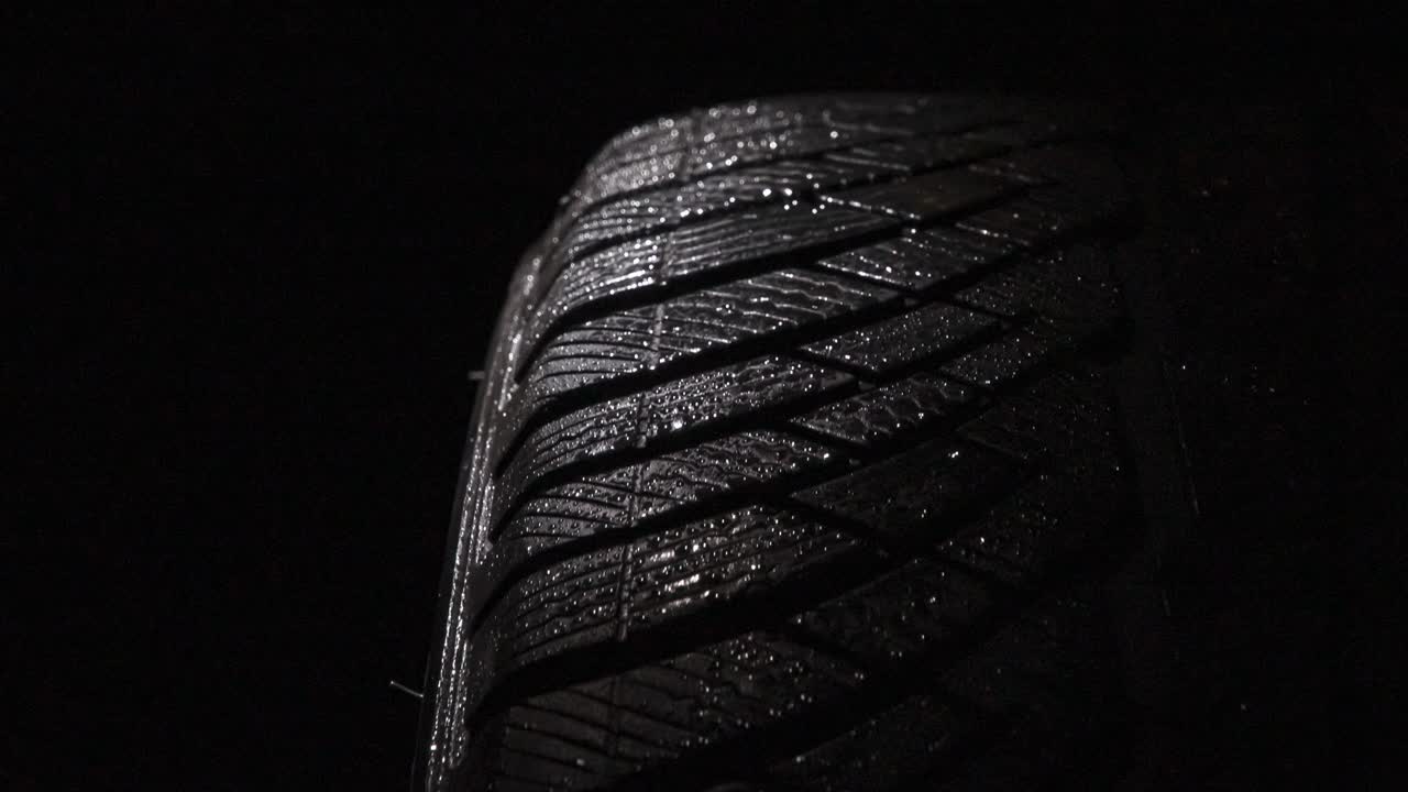 Car Tire in Water Droplets. Loop