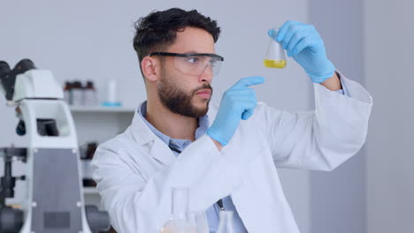 serious male scientist analyzing liquid