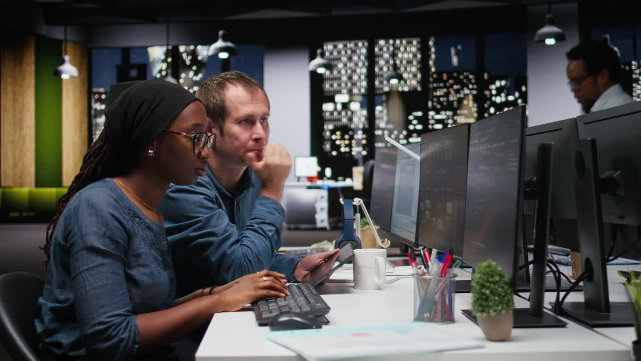 Two Software Engineers Collaborating on Code in a Modern Office