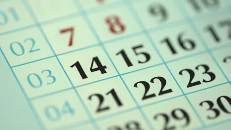 14th – fourteenth day of the month. the woman marks the calendar date with a blue marker