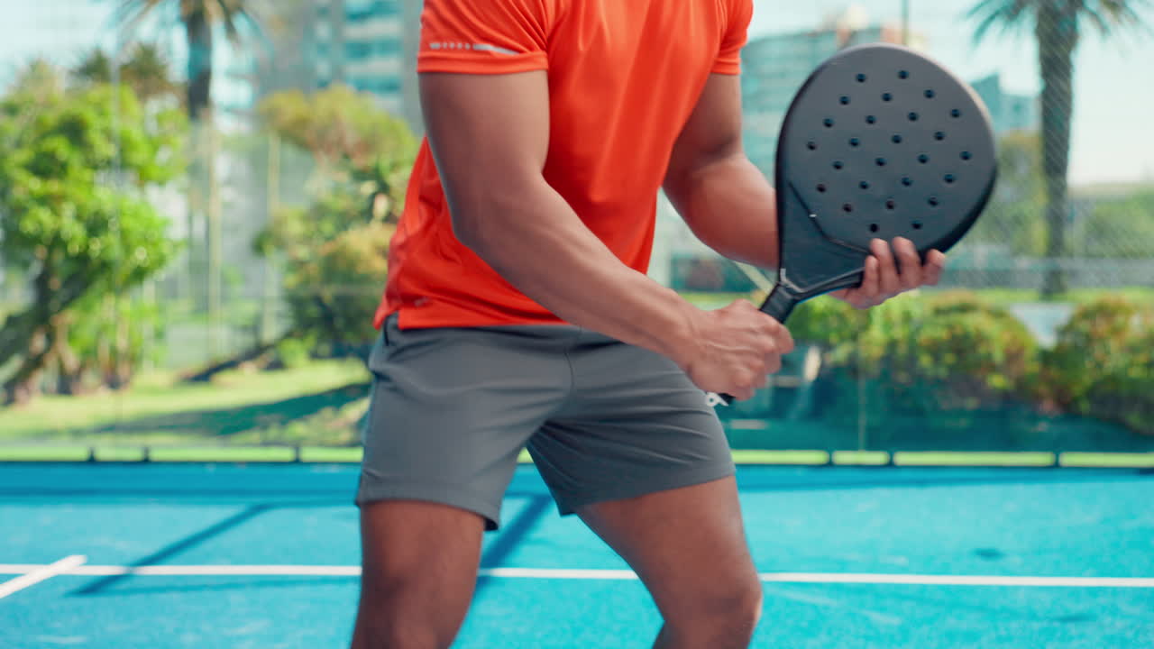 Man Playing Padel Tennis on a Blue Outdoor Court