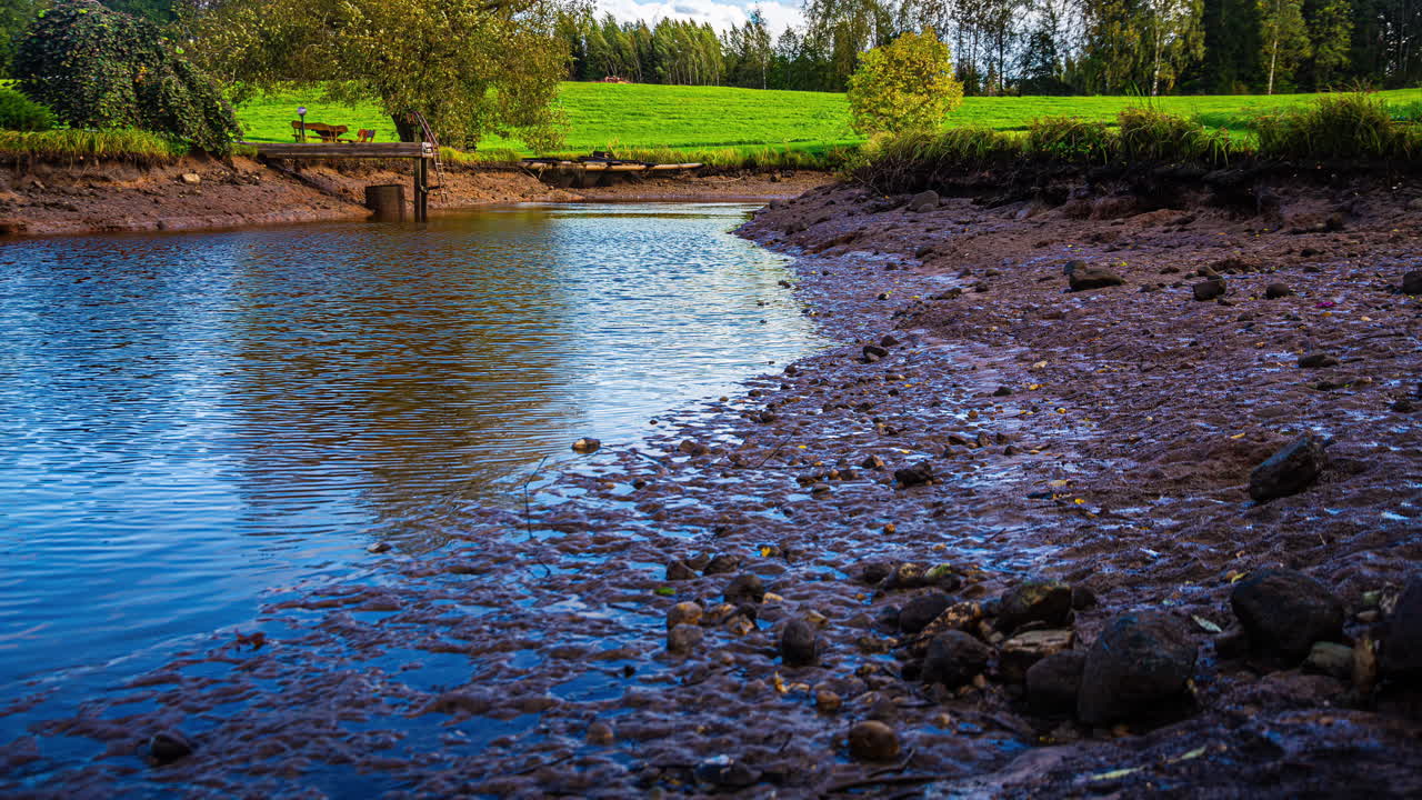 River Low Tide At Sunset With Rural Nature Background. Timelapse