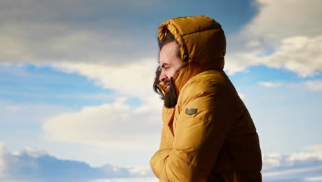 adventure seeker climbing the mountain with extreme windy weather
