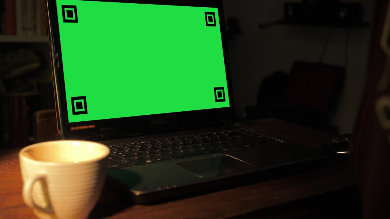 Laptop with Green Screen Display and Hand Drinking Coffee