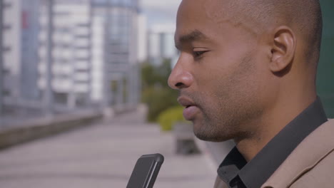 african american man having audio conference on smartphone