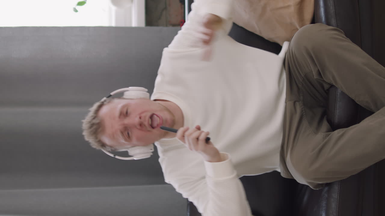 Vertical Portrait of Man Singing and Dancing to Song