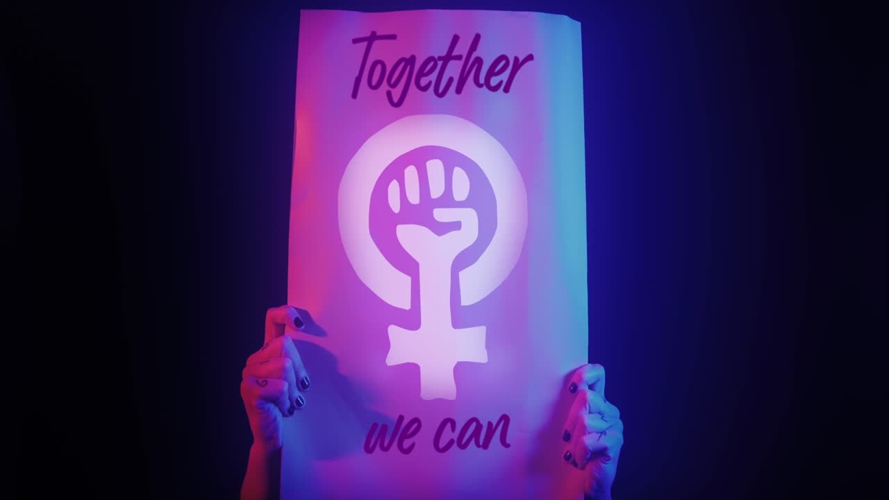 Hands Holding Glowing Feminist Protest Sign with Neon Lighting