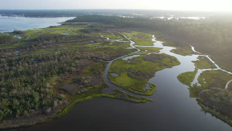 drone shot of salt marsh early in the morning with the sun rising