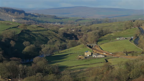 establishing drone shot of yorkshire dales landscape with trees winter