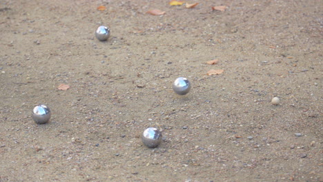 bocce ball game on a sand court
