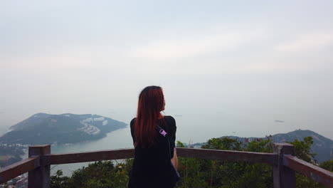 girl sitting and enjoying the view over stanley peninsula