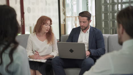 business meeting between two women and two men at an office 3