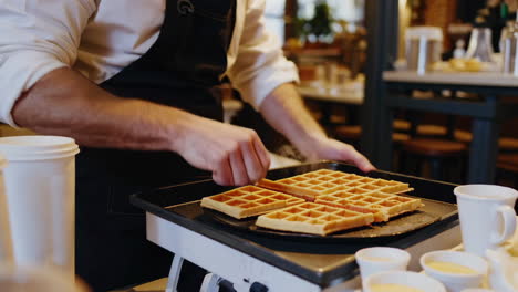 cafe worker preparing waffles and serving coffee