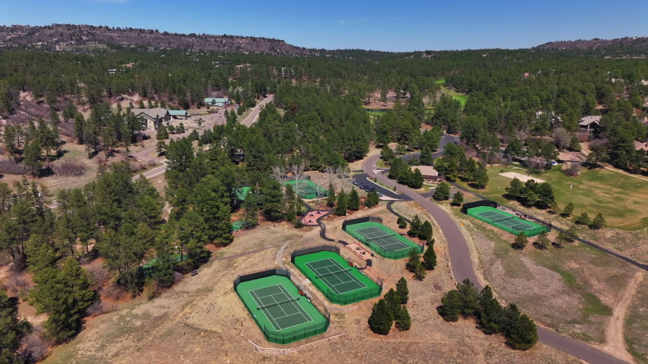 Castle Pines Village Golf Course spring aerial drone Colorado pickleball tennis courts club house front range morning gated community neighborhood homes cars roads forward pan up motion