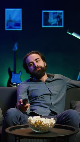 vertical video bored person scrolling through tv channel, frustrated by uninteresting content