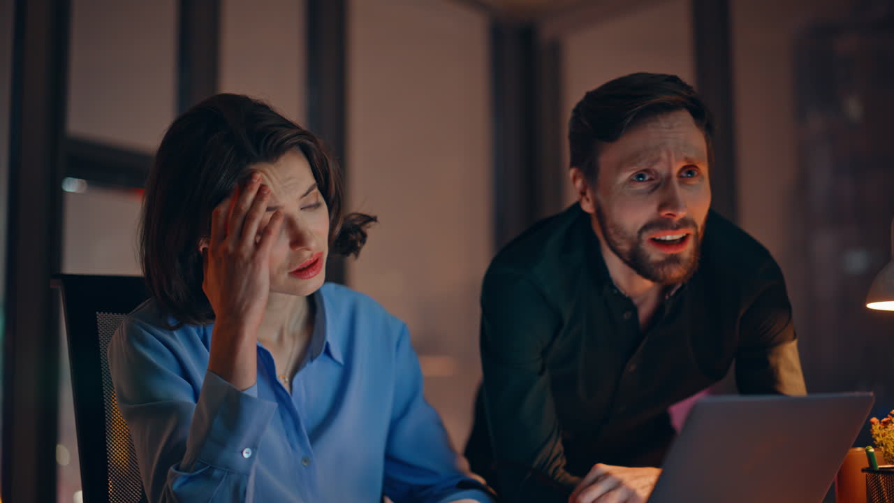 Business partners losing money looking laptop at dark office workplace closeup