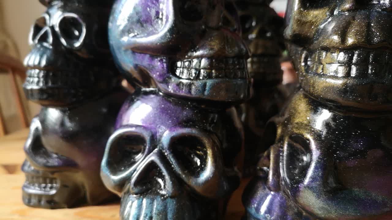 Multicoloured painted ceramic spooky death skull totem crafts pottery ornament slow reverse