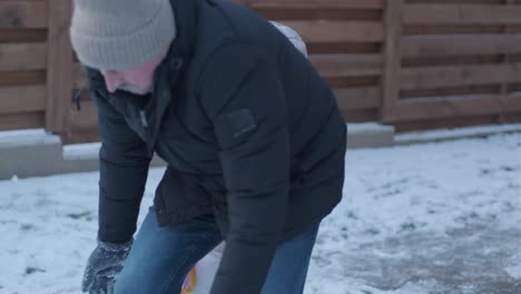 grandfather and granddaughter having fun in the snow