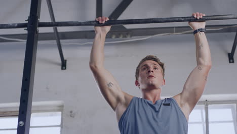 Sporty young man exercising on a chin up bar