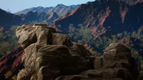 rugged rocky ledge overlooks a breathtaking mountain range
