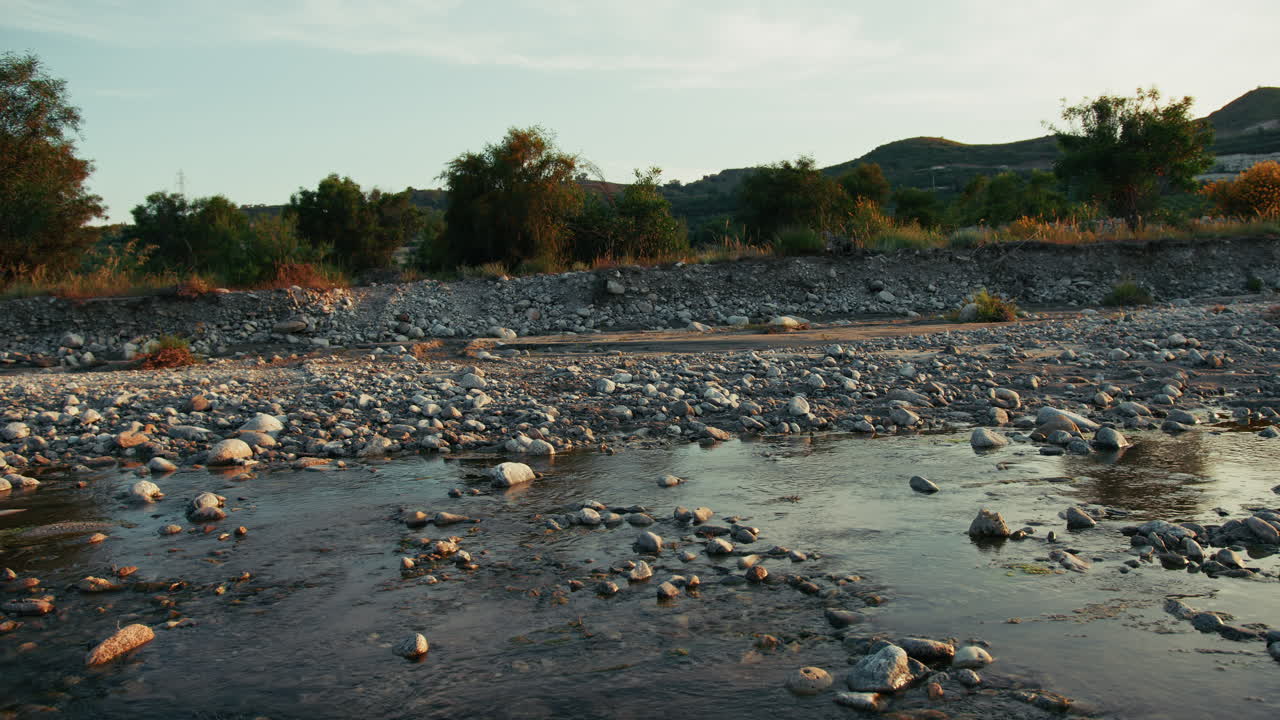 Rural Countryside Landscape In Calabria With A Slow Flowing River At Sunset