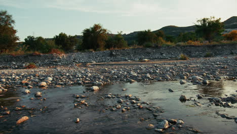 rural countryside landscape in calabria with a slow flowing river at sunset