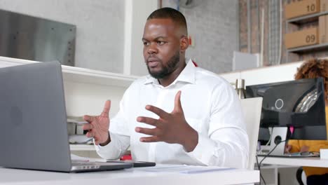 African-american-casual-businessman-having-laptop-video-call-talking-in-office,-slow-motion