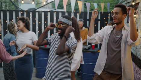 group of friends dancing at an outdoor party
