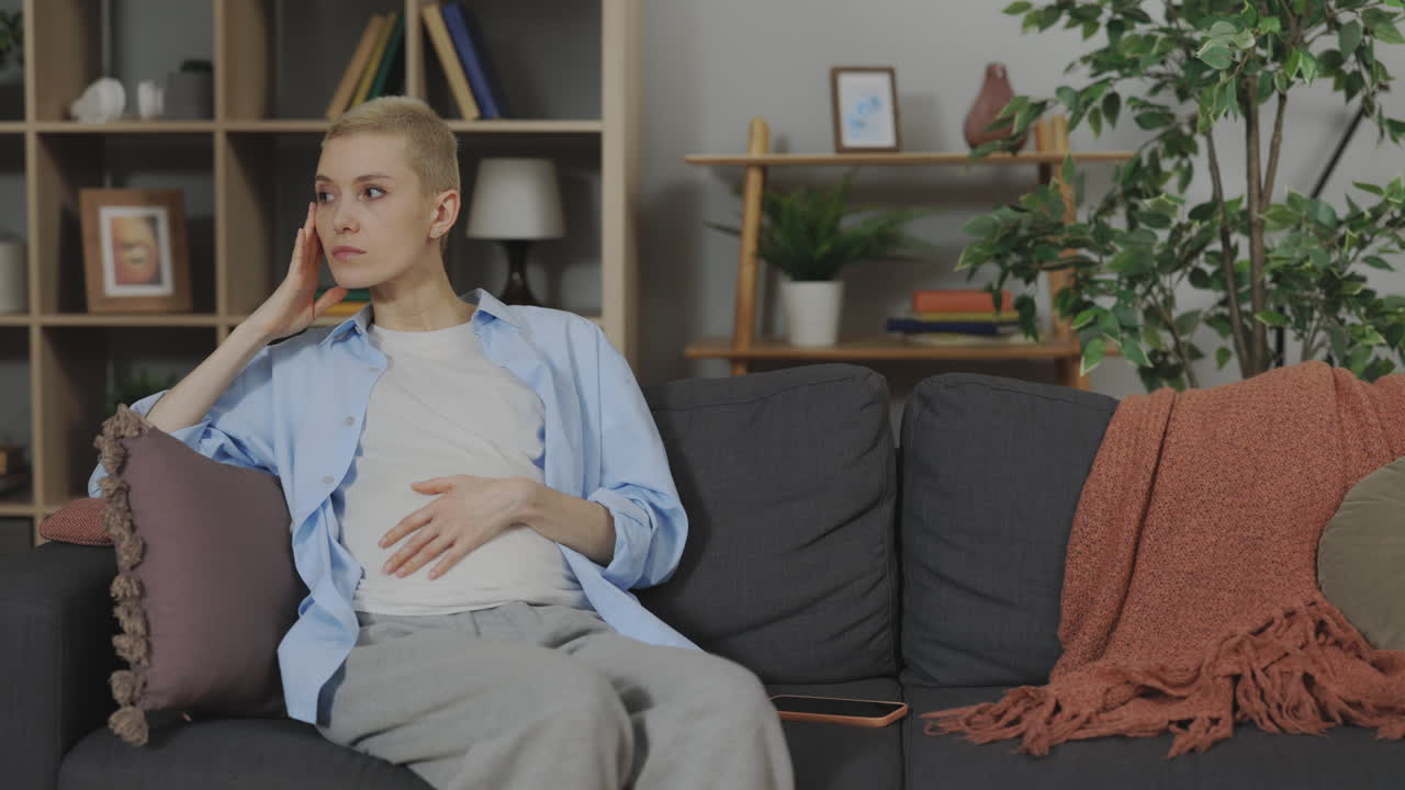 Woman experiencing discomfort on couch