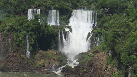 Iguazu-Falls-Waterfall-in-Brazil,-Amazing-Picturesque-Rainforest-Landscape-Surrounding-Colourful-Waterfalls-in-Jungle,-Beautiful-Trees-and-Green-Scenery-with-Two-Large-Double-Waterfalls