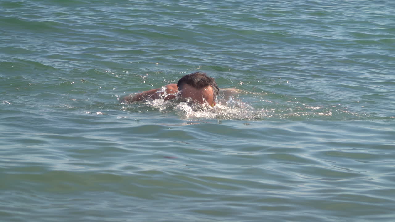 Man swimming in the sea on a sunny day
