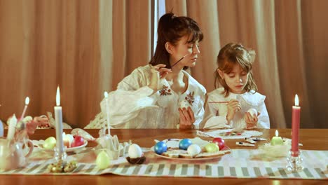 mother and daughter decorating easter eggs