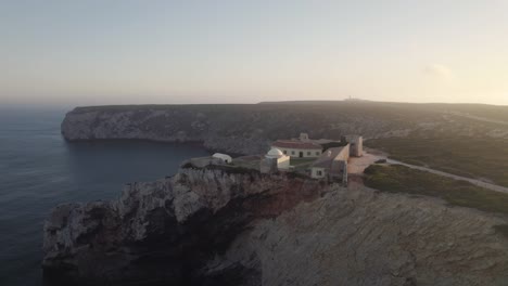 Dolly-out-seascape-view-of-Fortress-of-Beliche-located-on-top-of-rugged-cliff-in-Sagres-Algarve-Portugal