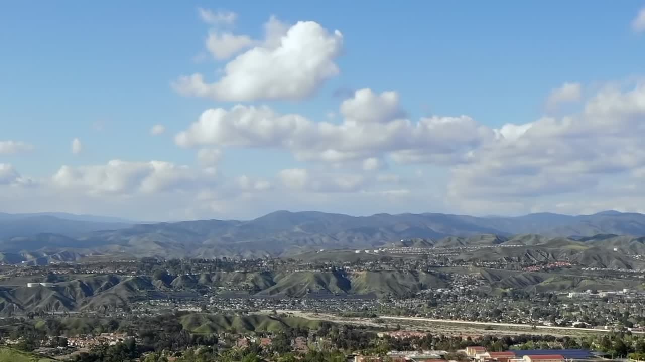 Aerial time lapse of clouds over Los Angeles residential suburb neighborhood