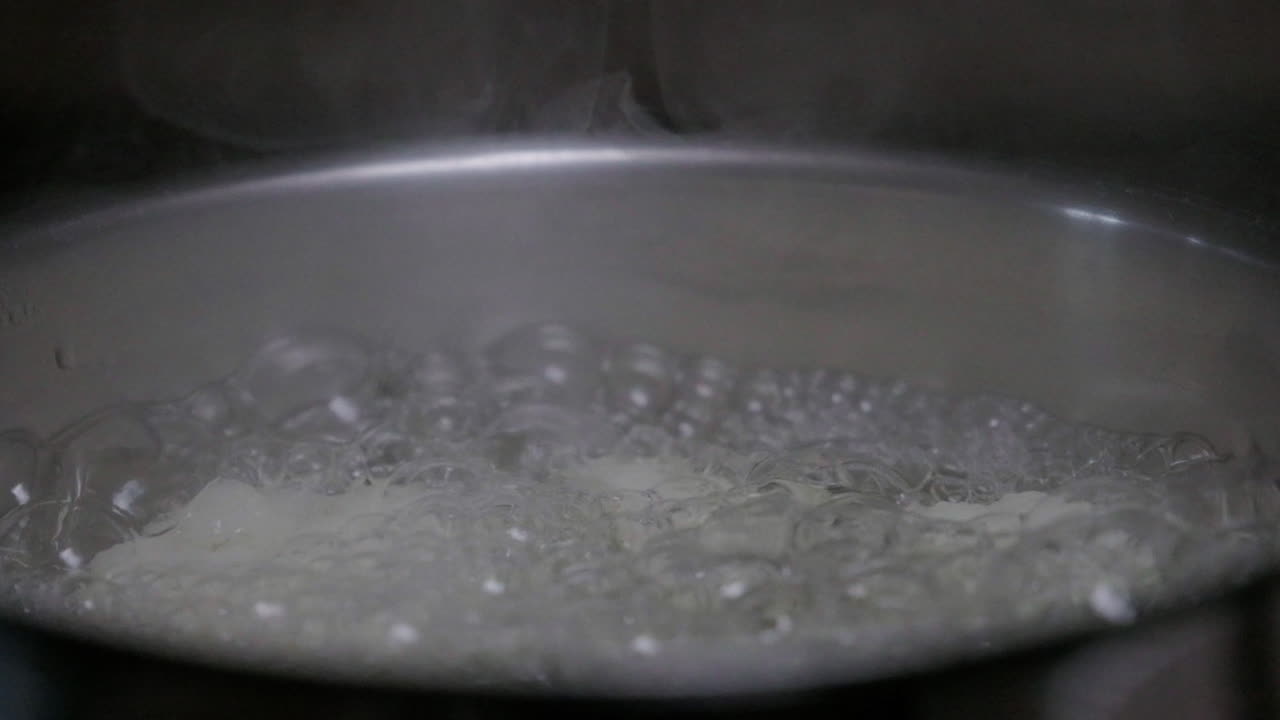 Cauliflower boiling in a pan with steam