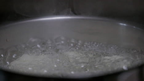 cauliflower boiling in a pan with steam