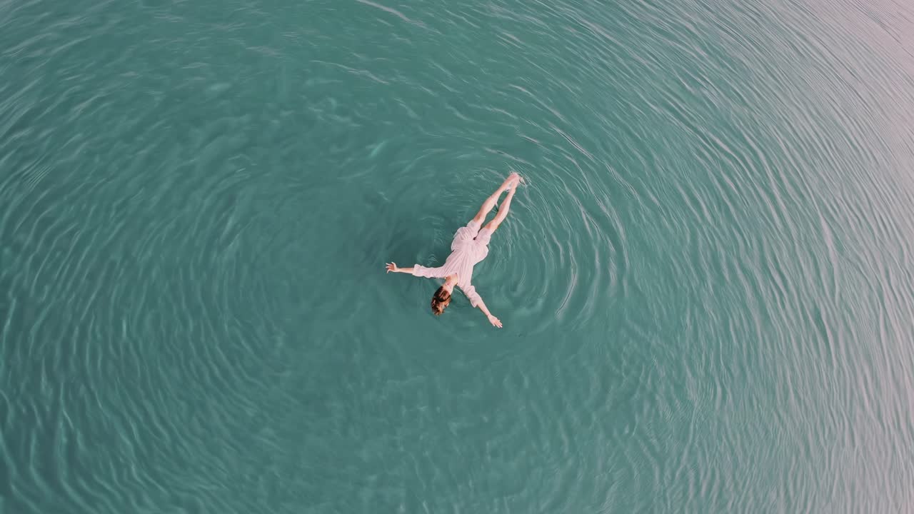 Woman Floating in Calm Water