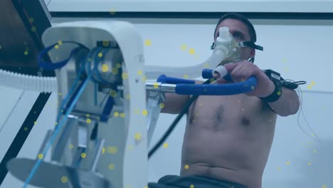 animation of spots over caucasian man exercising with lab equipment