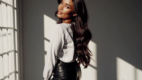 stylish woman in white shirt and black leather pants