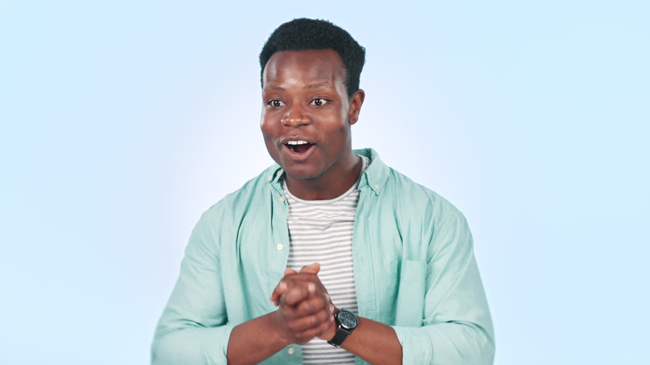 African man, surprise and celebration in studio