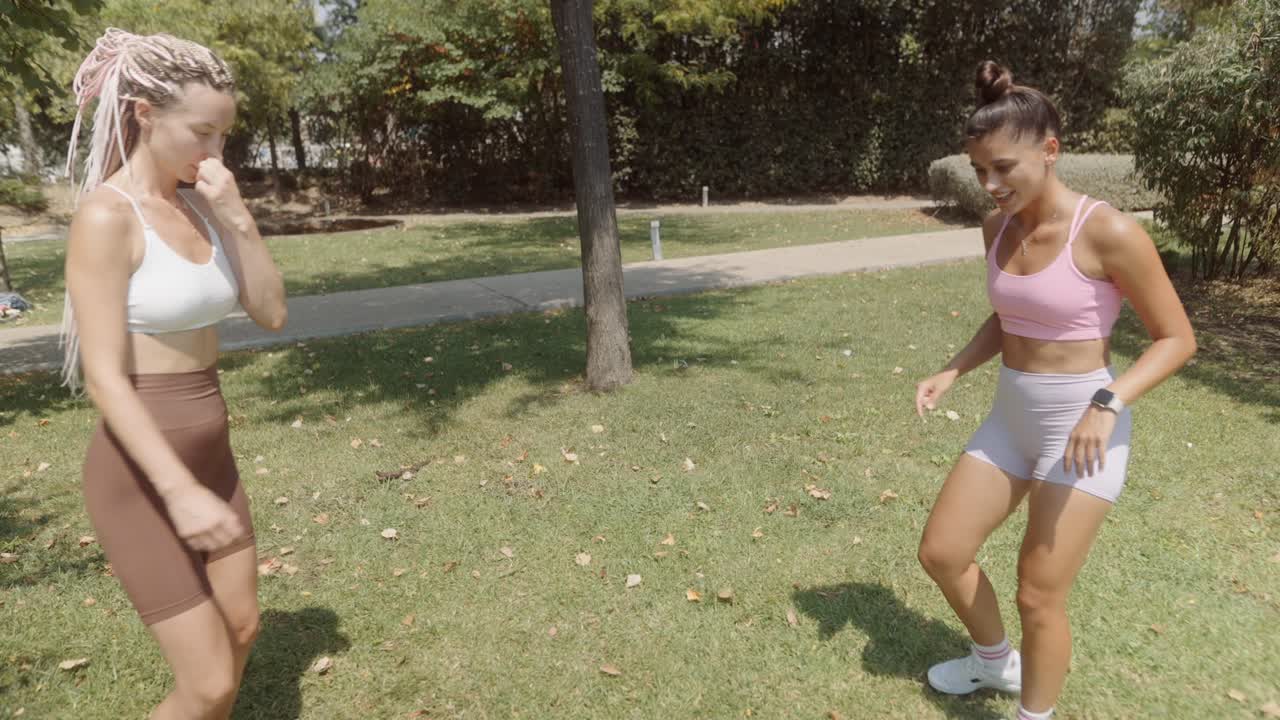 Women playing soccer in the park