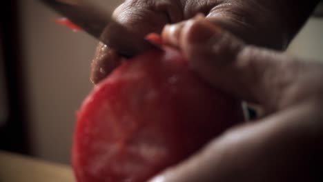 close-up-of-hands-peeling-a-very-red-tomato