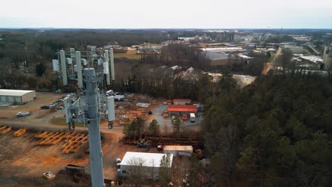 Aerial-Tilting-Shot-of-Cell-Phone-Tower-in-Forest