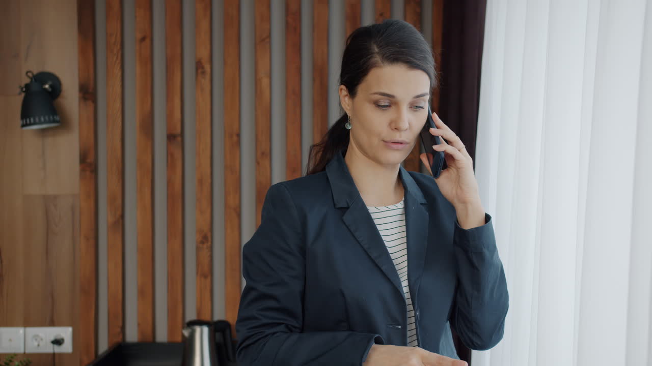 Businesswoman Talking on Phone in Hotel Room