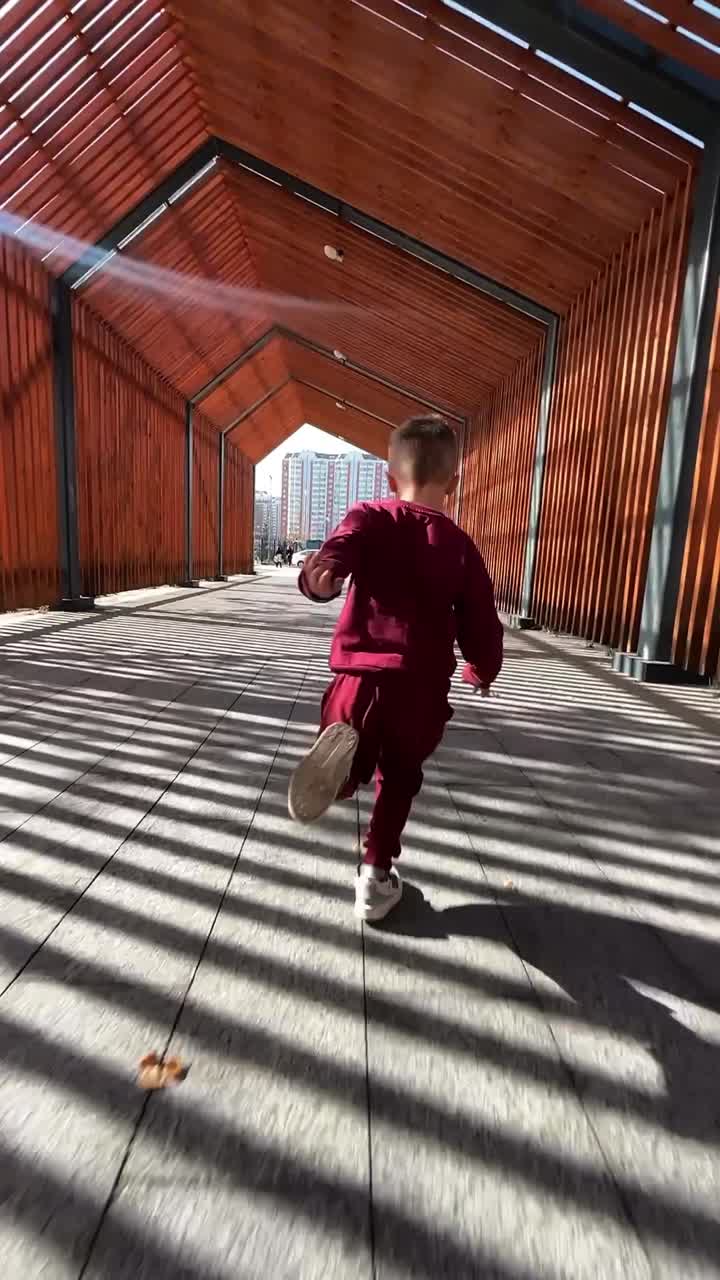 Boy running through a tunnel