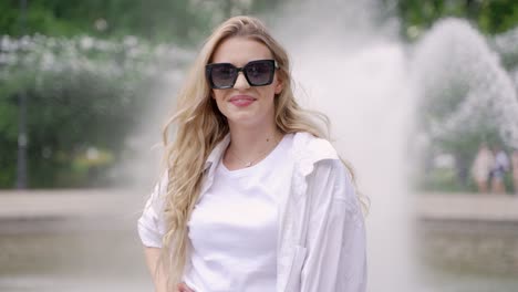 woman posing in a park by a fountain