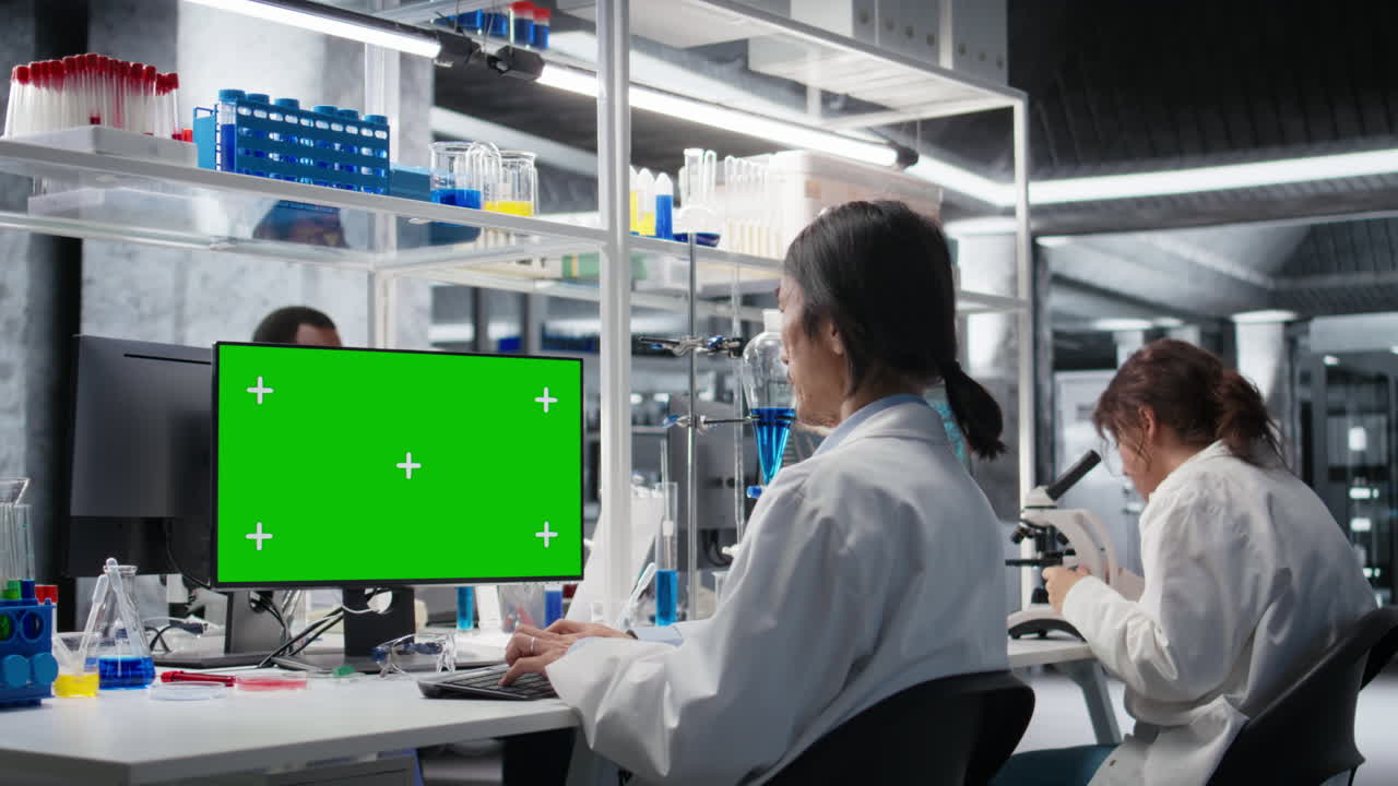 Vertical video Lab technician using green screen computer for DNA data analysis
