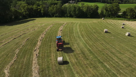 straw bale rolling out of farming machinery