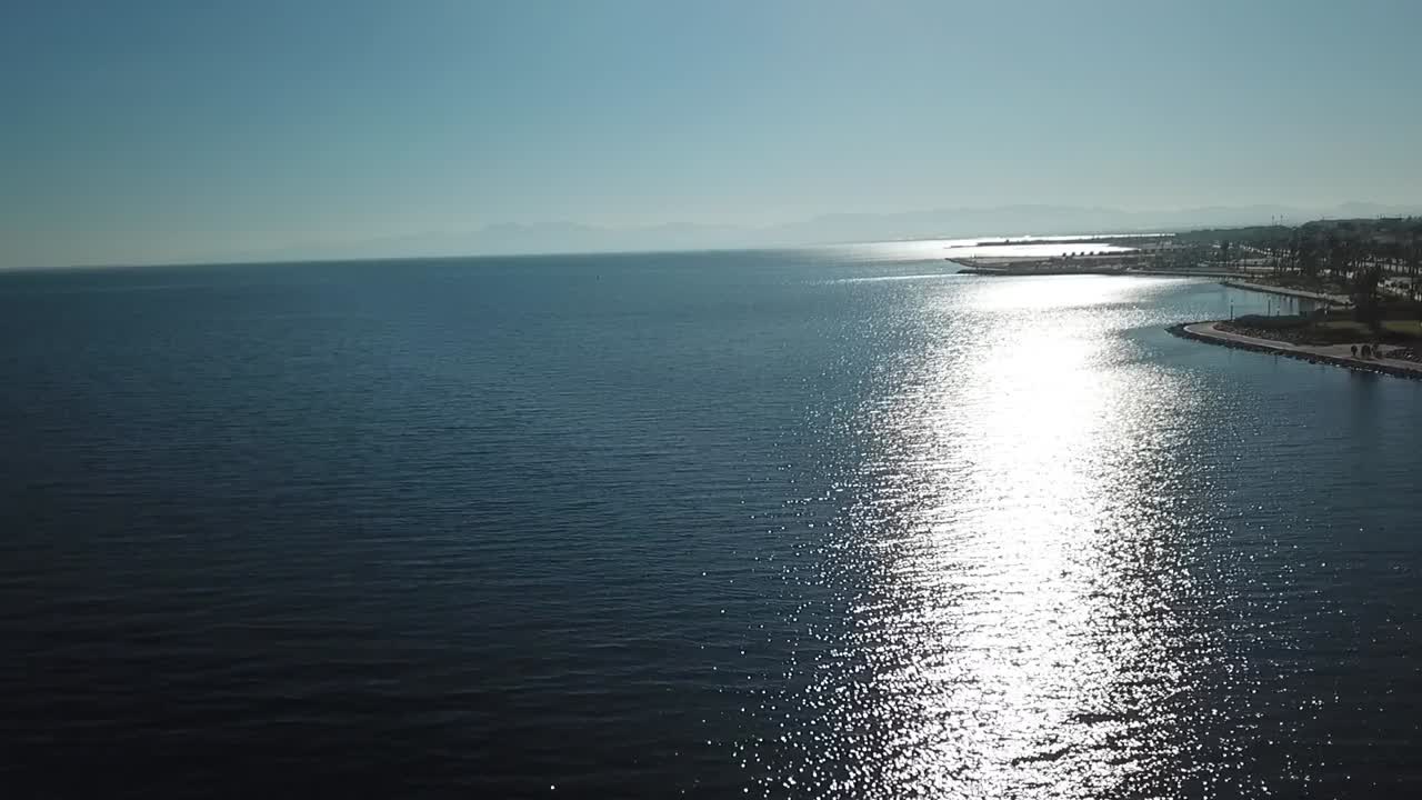 Calm Mediterranean waves along a modern corniche in northern Morocco, showing serene coastal scenery and clean waterfront views