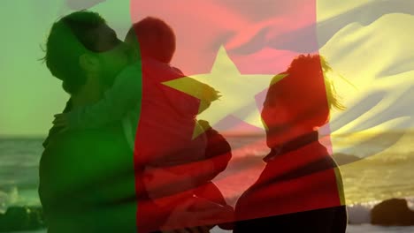 animation of flag of cameroon over caucasian parents with child at beach